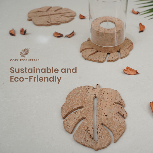 Set of leaf-shaped coasters with a glass of dark liquid on a white background