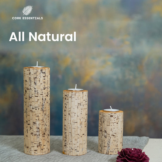 Three cylindrical candles with bark-like texture and a purple flower on a white background