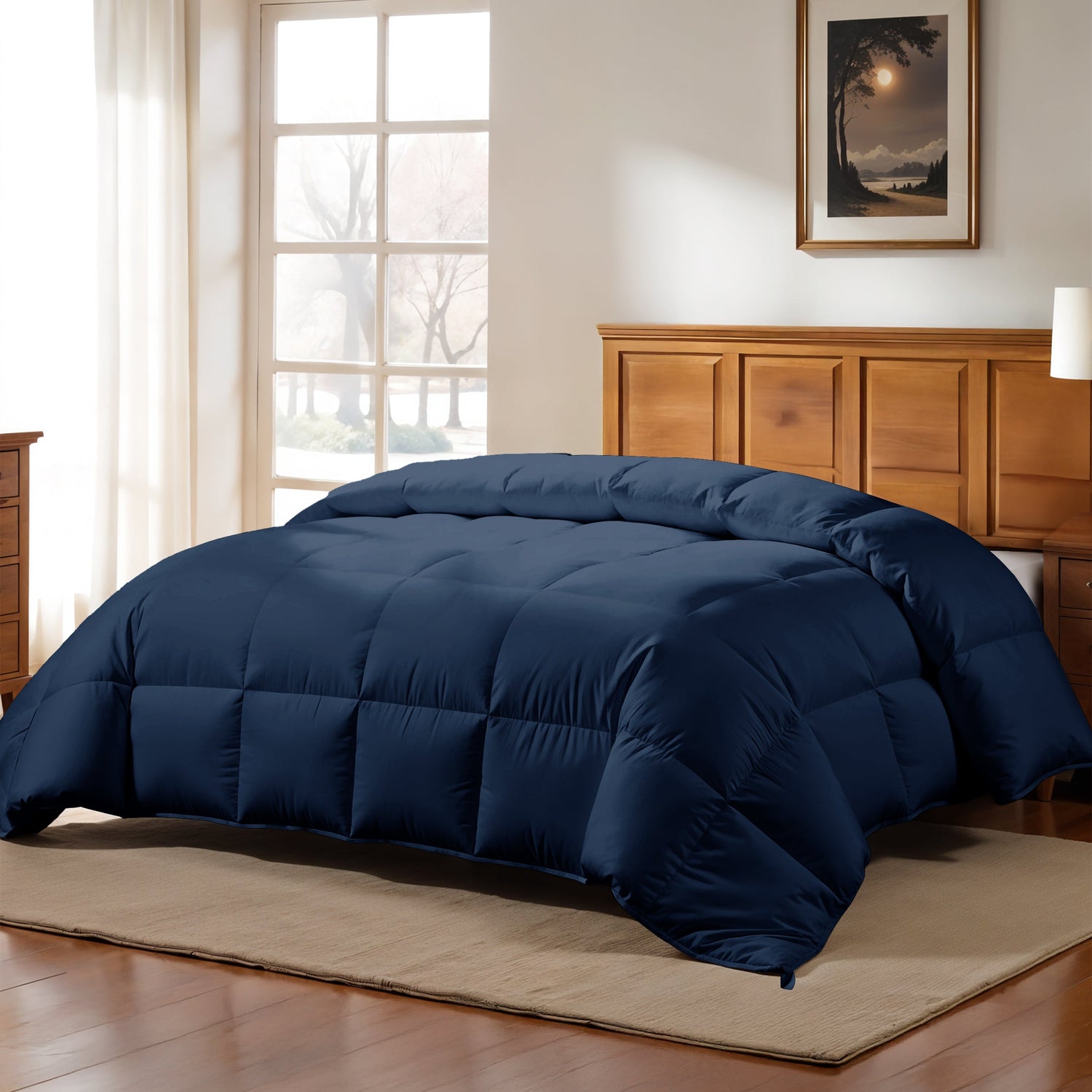 Navy blue comforter on a bed in a bedroom with wooden furniture and a window.