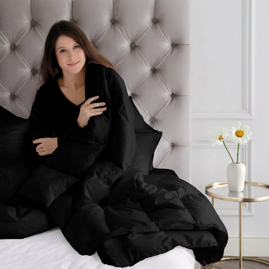 Black comforter on a bed in a modern bedroom setting