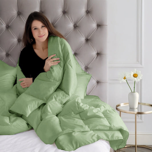 Green comforter on a bed in a modern bedroom setting