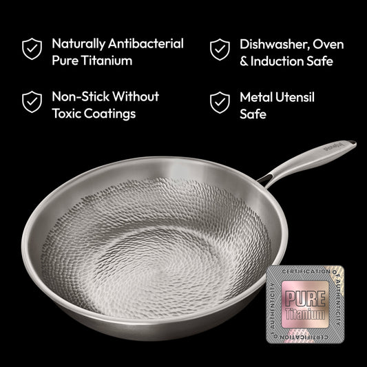 Stainless steel frying pan with textured surface on a white background