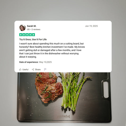 Gray cutting board with a handle on a white background