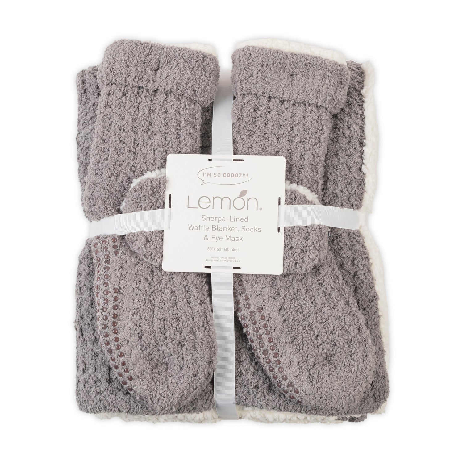 Gray textured blanket, socks, and eye mask set with Lemon label on a white background