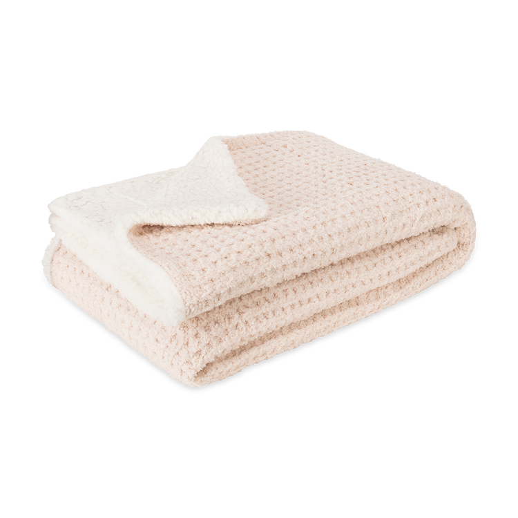Folded beige blanket with white interior on a white background