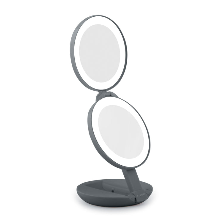 Makeup mirror with two circular mirrors on a stand against a white background