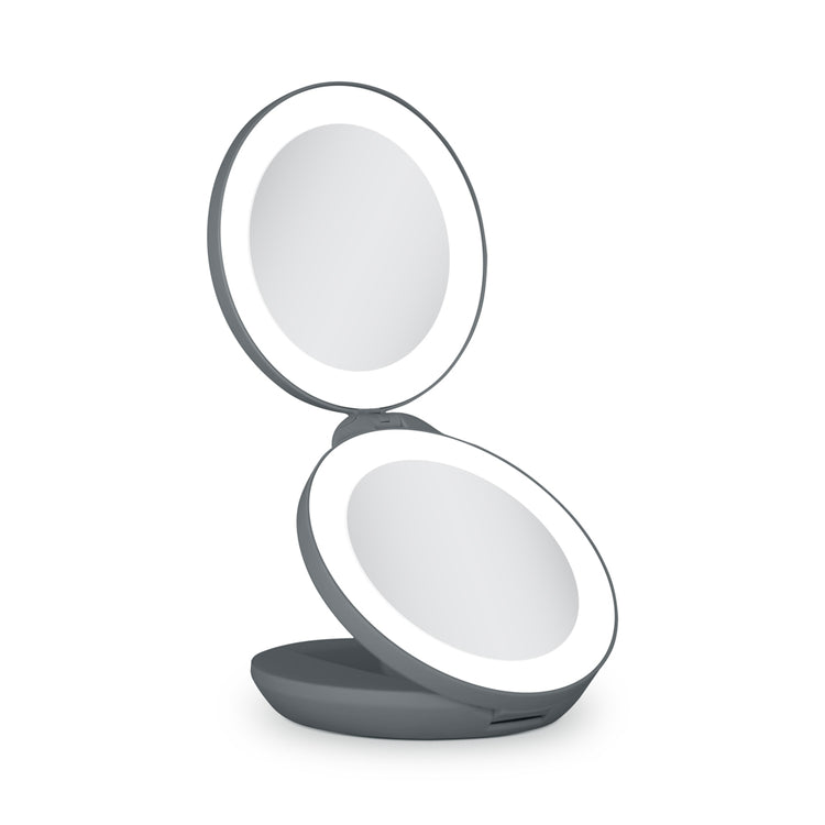 Compact mirror with a light on a white background