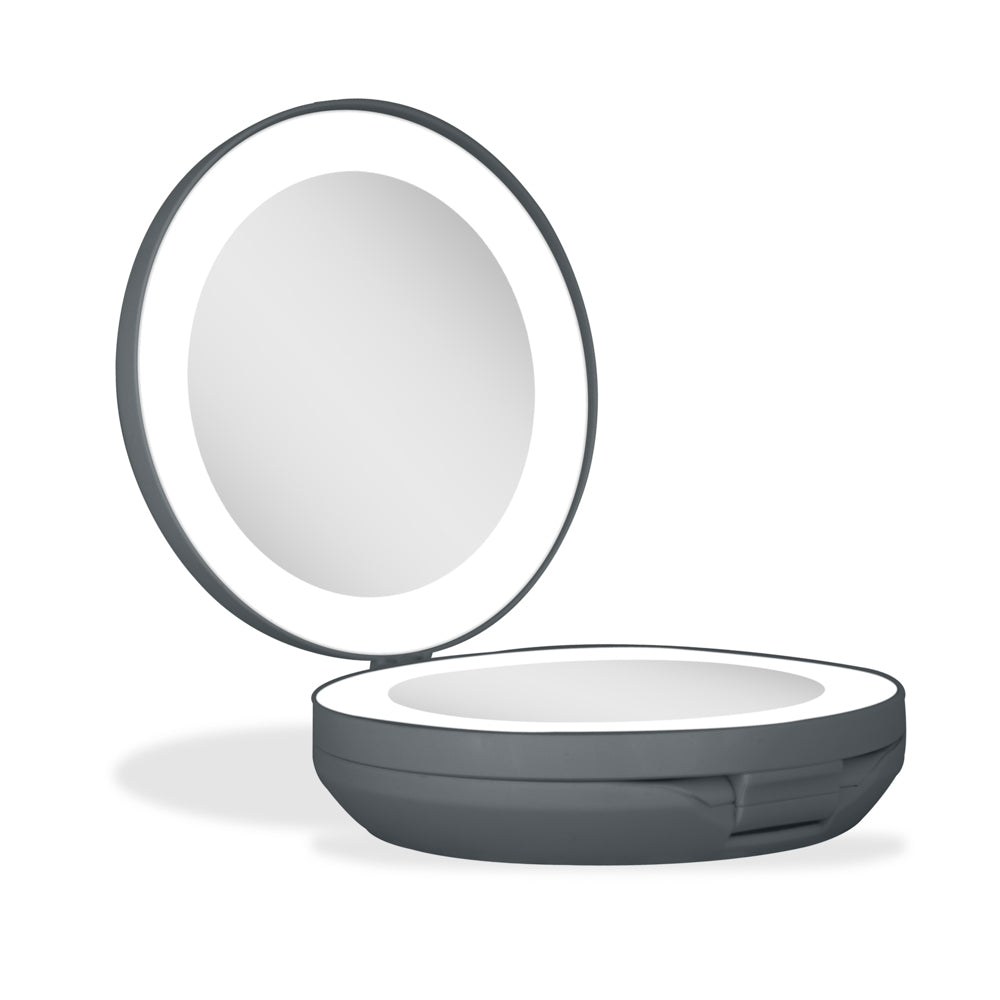 Compact mirror with a light on a white background