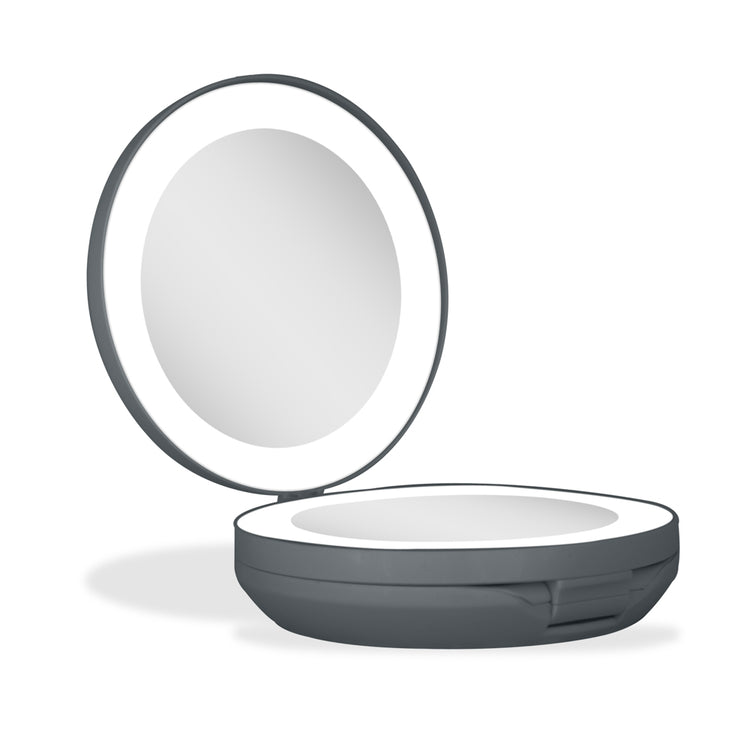 Compact mirror with a light on a white background