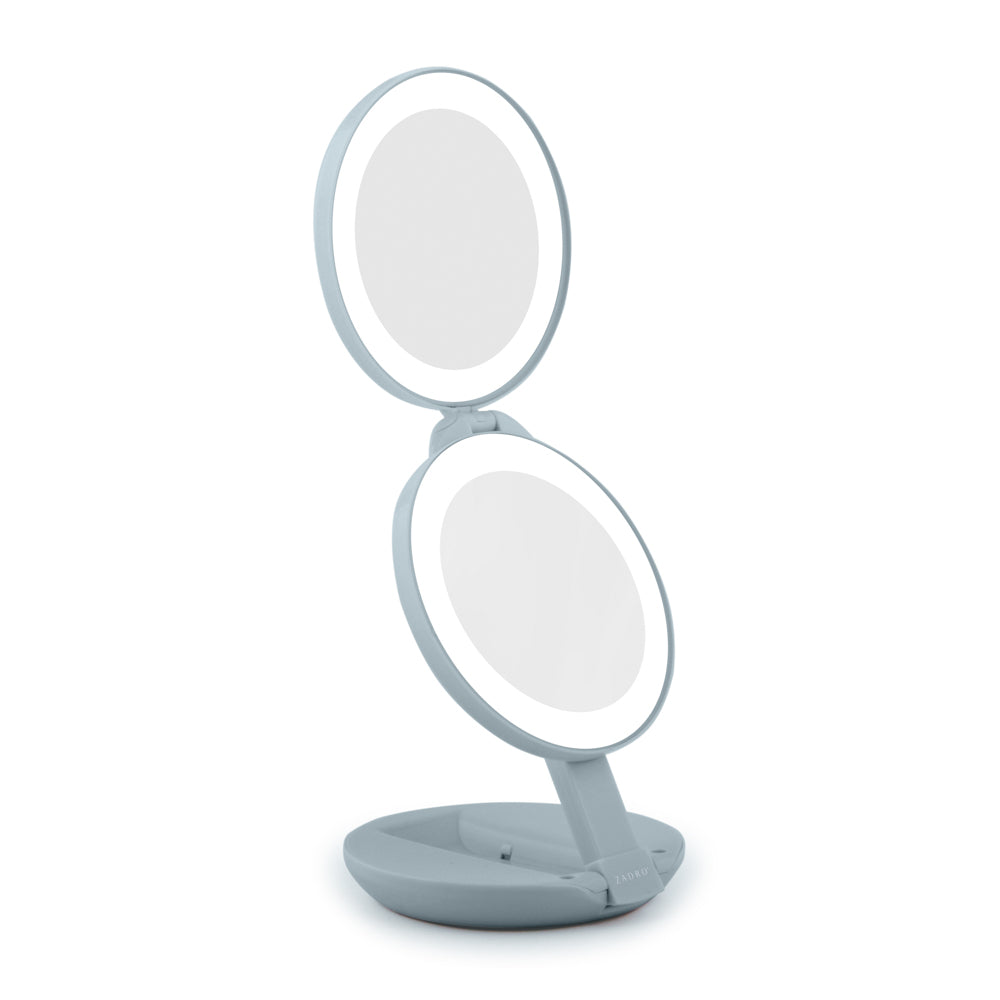 Double-sided makeup mirror with LED lights on a white background