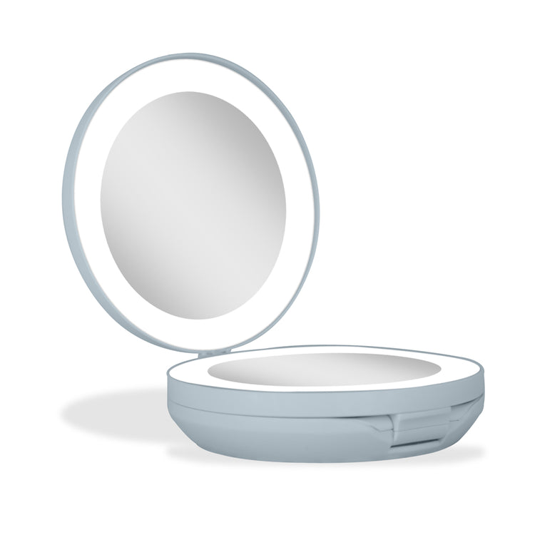 Compact mirror with a light blue casing on a white background