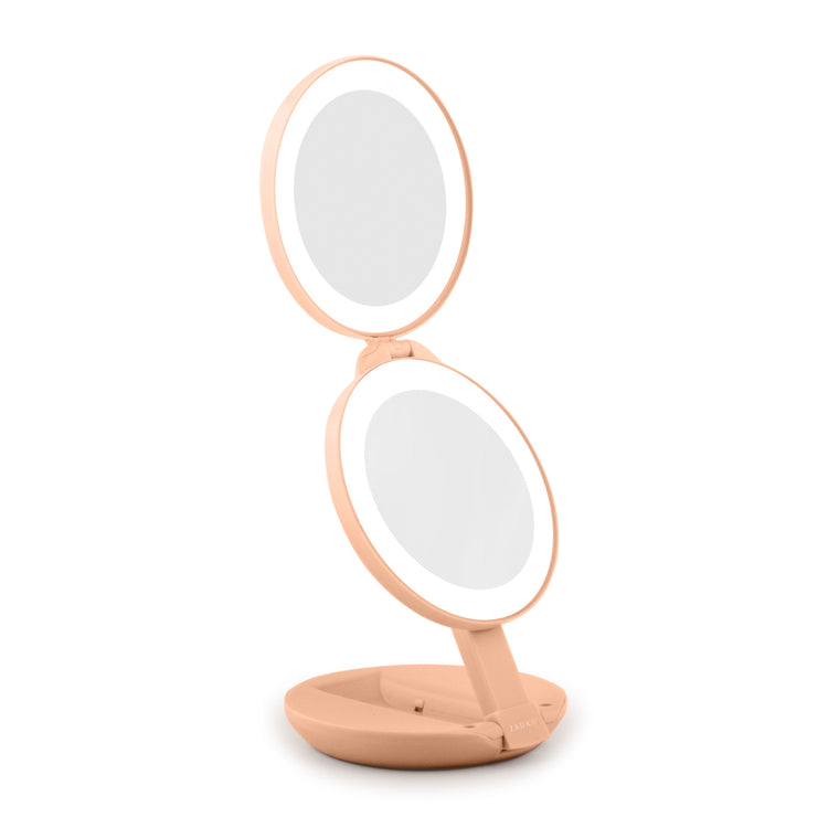 Double-sided vanity mirror with lighted surface on a white background
