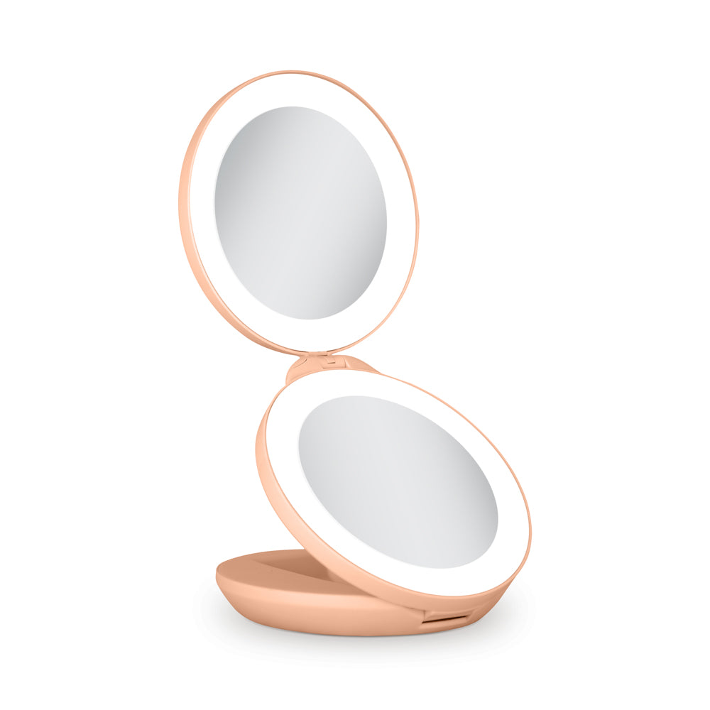 Compact mirror with a rose gold frame on a white background