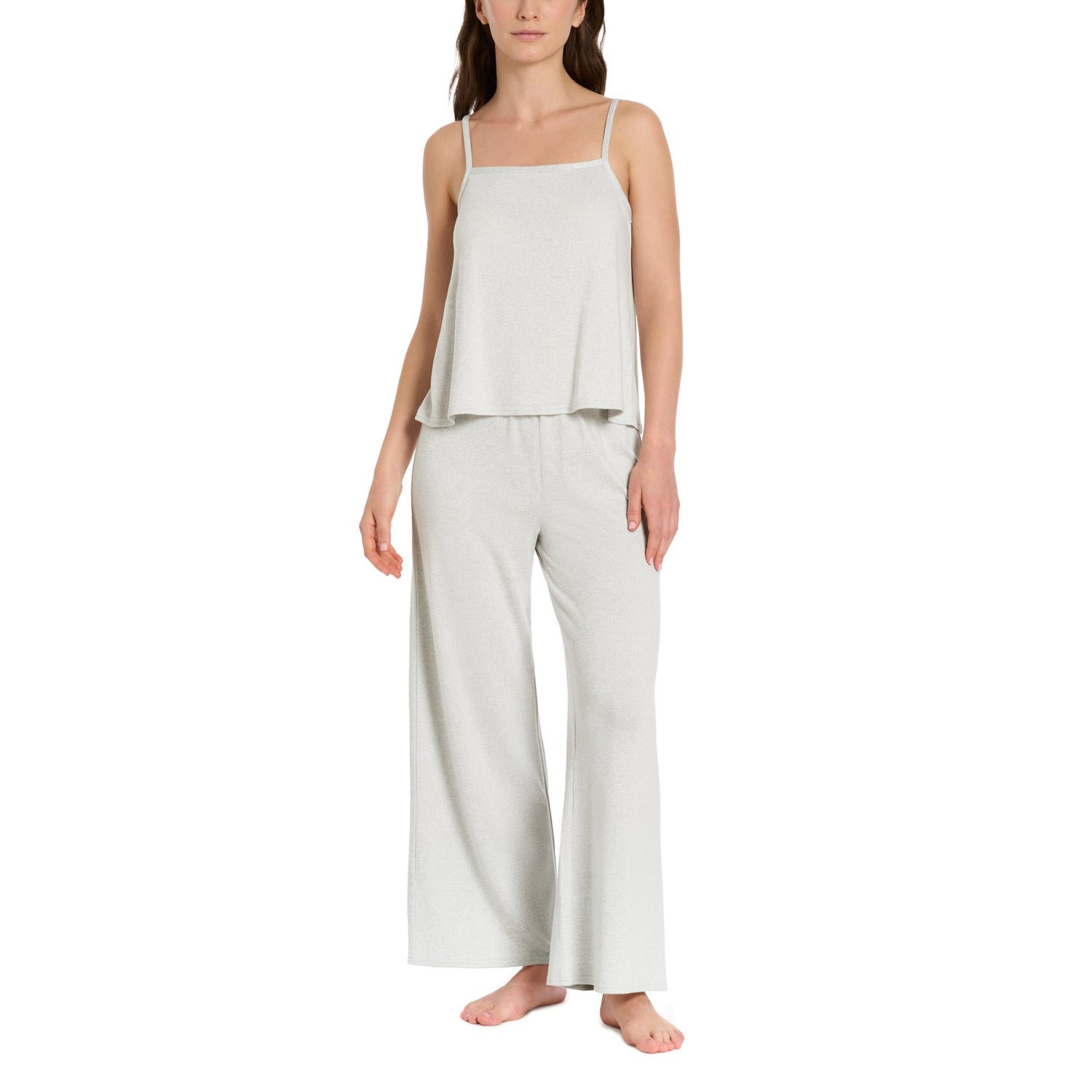 Woman wearing a light gray sleeveless top and wide-leg pants on a white background