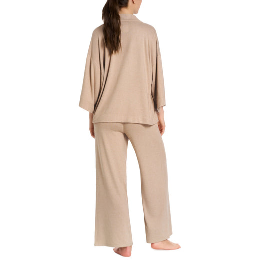 Woman wearing a beige loungewear set on a white background