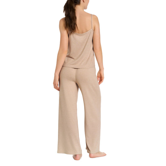 Woman wearing a beige loungewear set on a white background