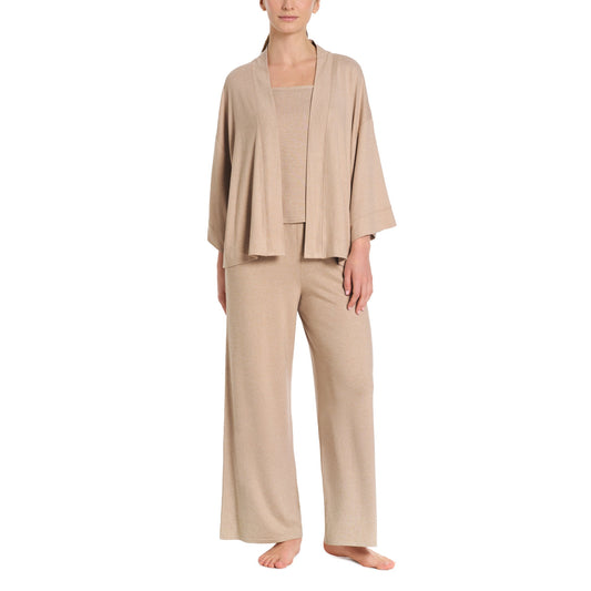 Woman wearing a beige loungewear set on a white background