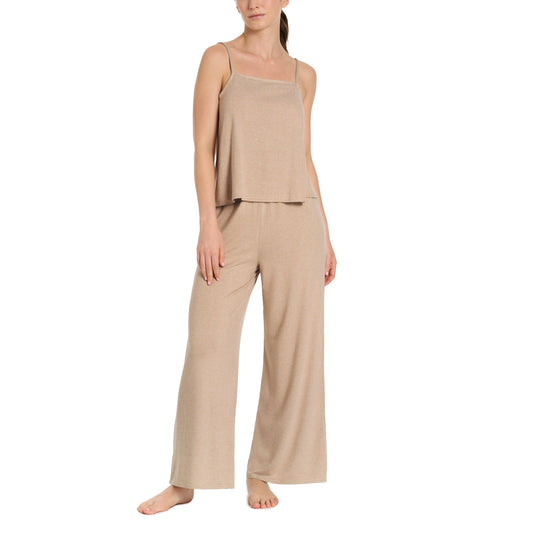 Woman wearing a beige loungewear set on a white background