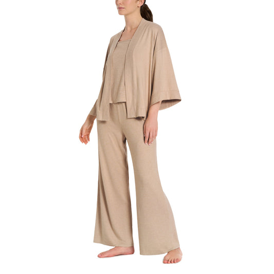 Woman wearing a beige loungewear set on a white background