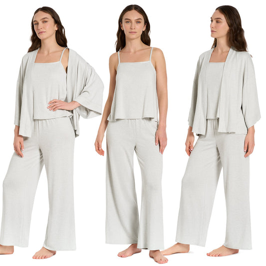 Woman wearing a light gray outfit with a matching jacket on a white background