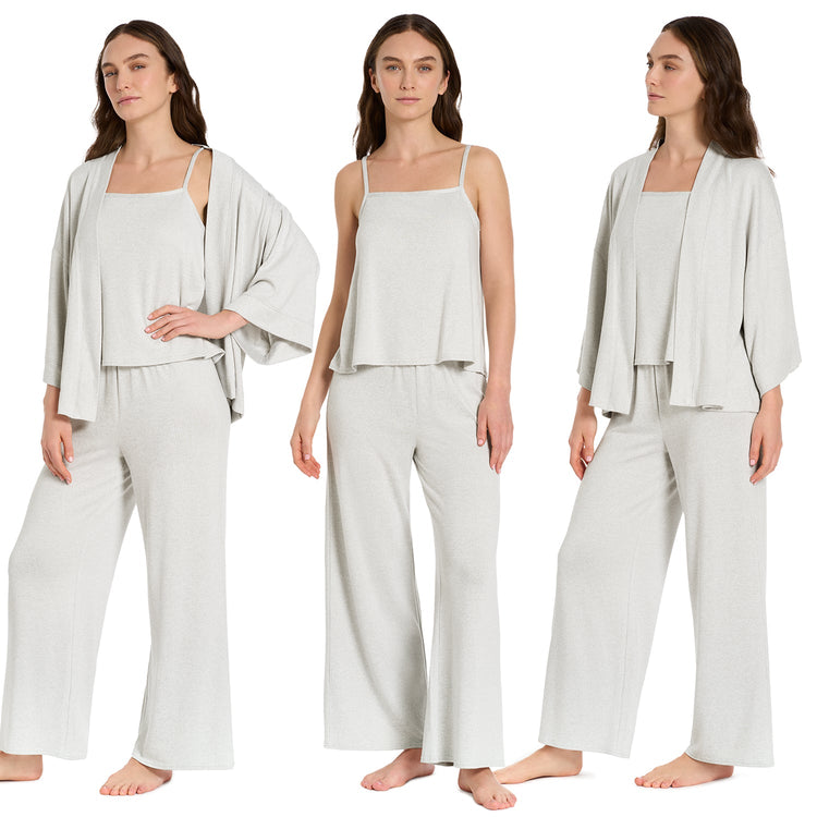 Woman wearing a light gray outfit with a matching jacket on a white background