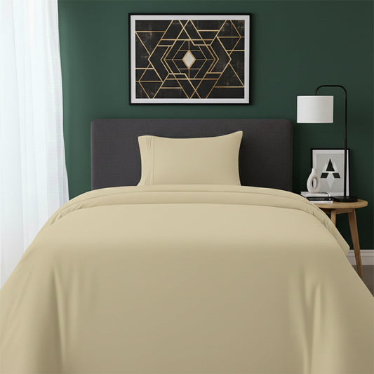 Red bedspread on a wooden bed with a white nightstand and decor items in the background.