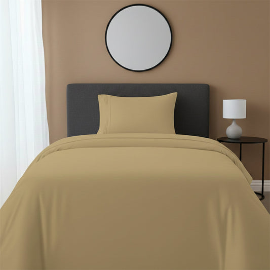 Red bedspread on a wooden bed with a white nightstand and decor items in the background.