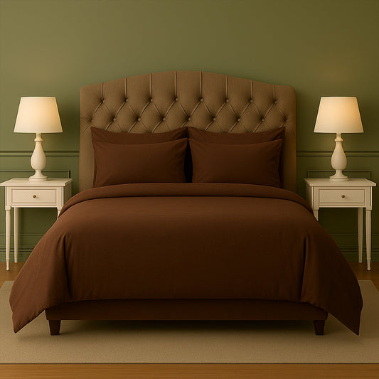 Neatly made bed with beige bedding in a bedroom setting.