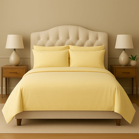 Purple bedding set on a bed with matching pillows in a room with purple walls and wooden nightstands.