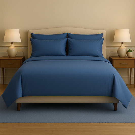 Neatly made bed with beige bedding in a bedroom setting.