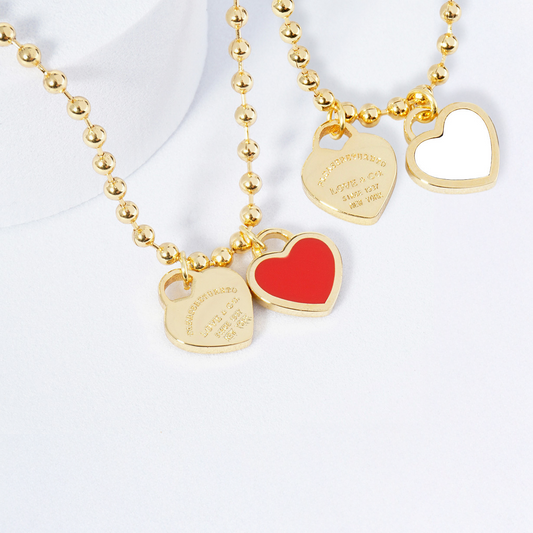 Gold necklace with heart-shaped pendants on a white background