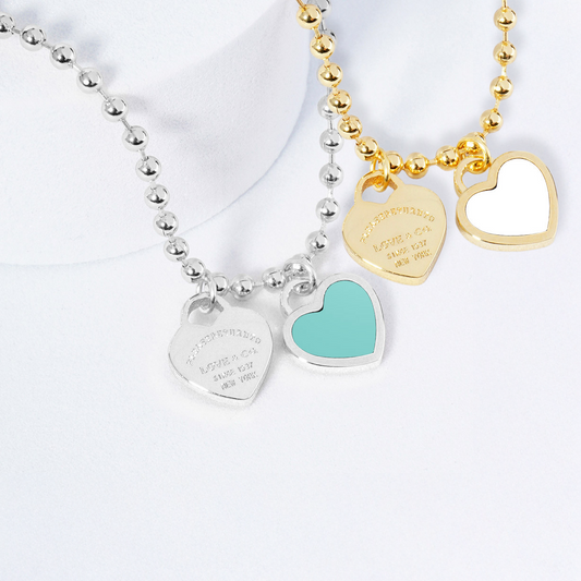 Two necklaces on mannequin busts with a blurred background