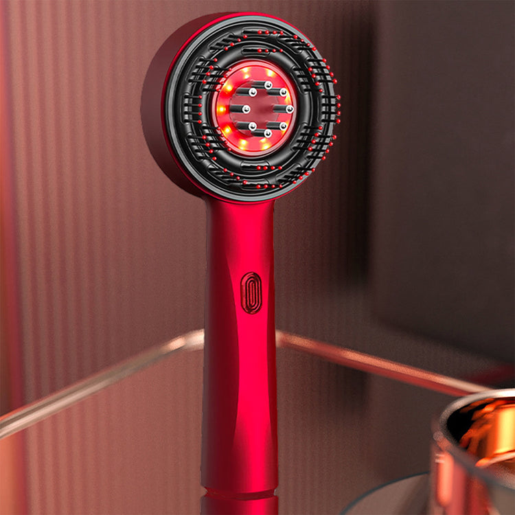Red hair dryer with a black nozzle on a reflective surface