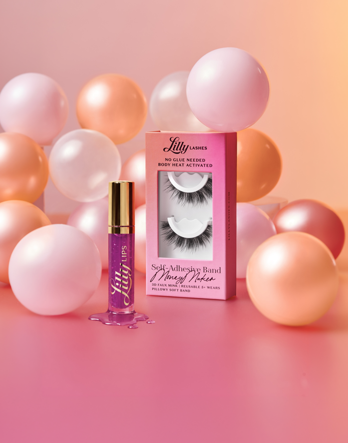 Lilly Lashes self-adhesive band and eyelash packaging with balloons on a pink background