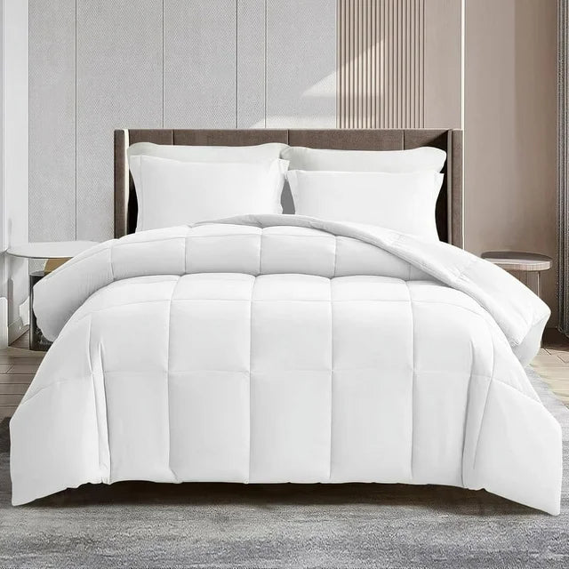 White comforter set on a bed in a bedroom setting