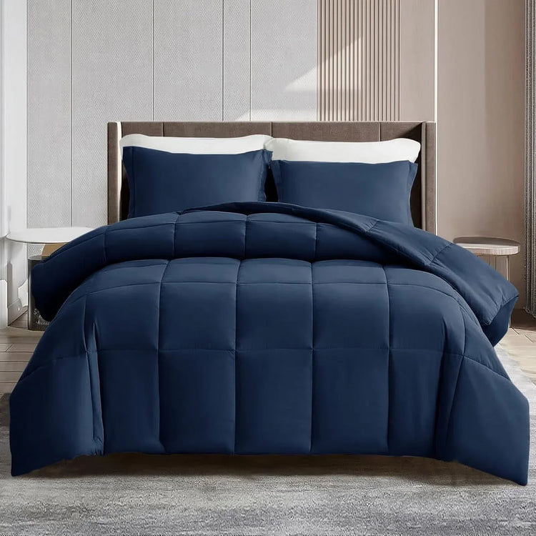 Navy blue comforter set on a bed in a bedroom setting