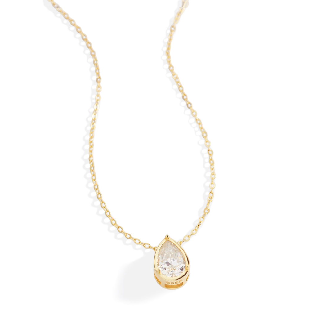 Gold necklace with a teardrop-shaped diamond pendant on a white background