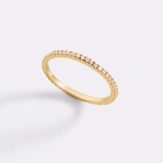 Gold ring with small diamonds on a white background