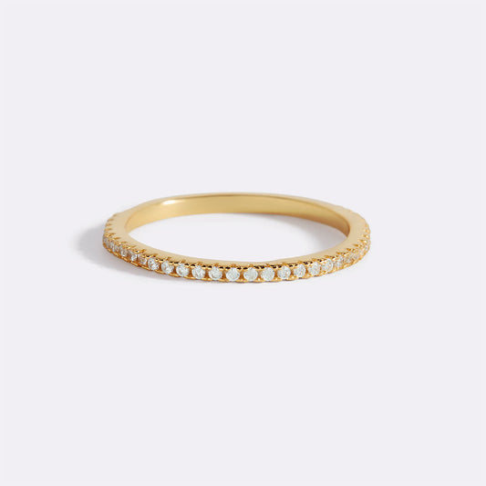 Gold ring with small diamonds on a white background