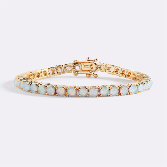 Gold bracelet with opal stones on a white background