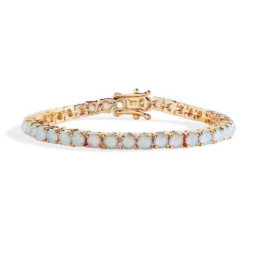 Gold bracelet with opal stones on a white background