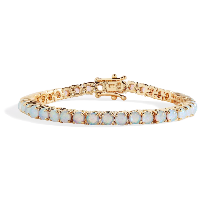 Gold bracelet with opal stones on a white background