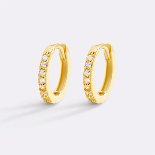 Gold hoop earrings with small diamonds on a white background