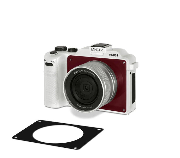 Minolta camera with a lens cap on a white background