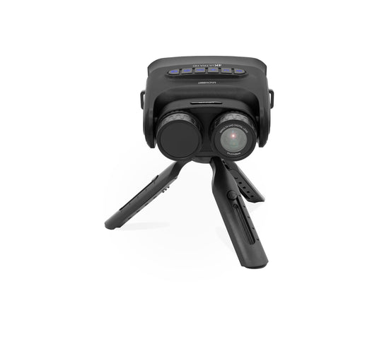 A green and black thermal imaging scope mounted on a small black tripod, shown against a plain white background.