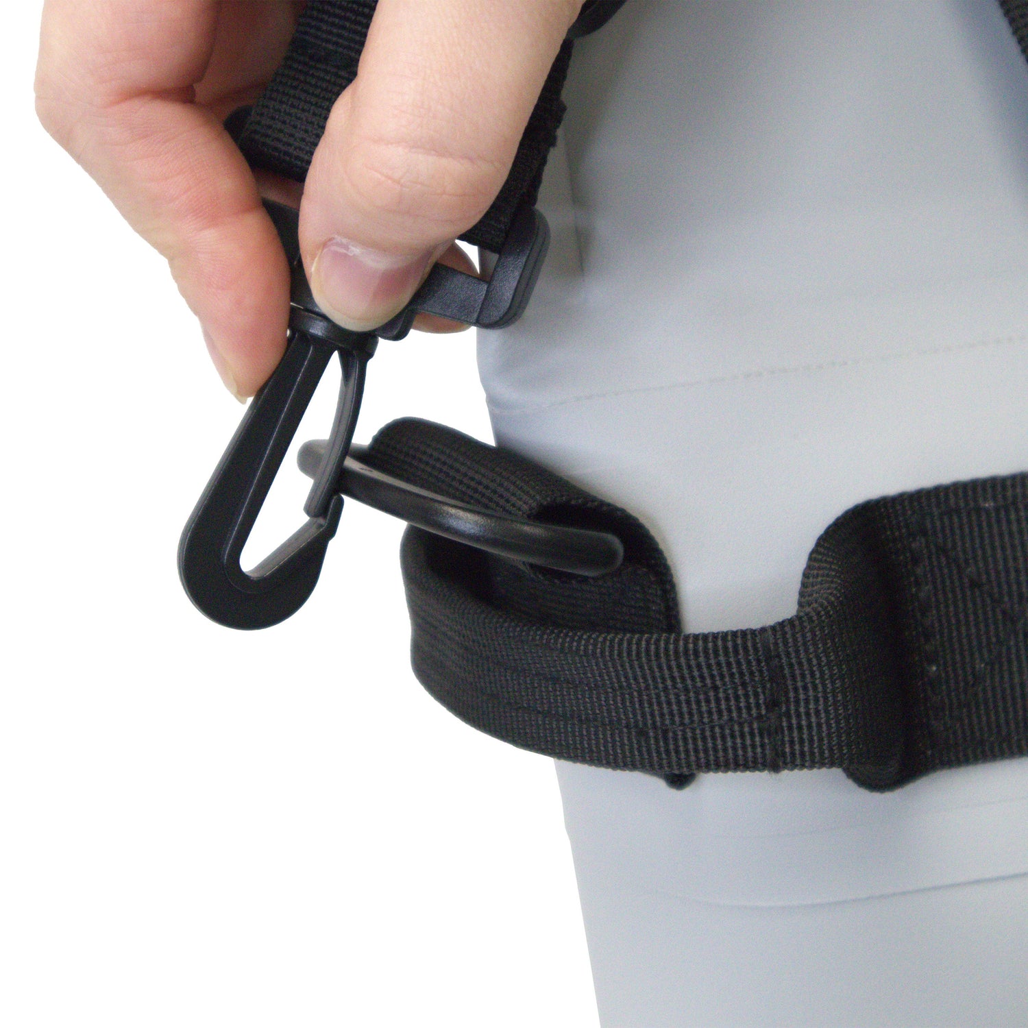 Person adjusting a black belt with a carabiner on a white background