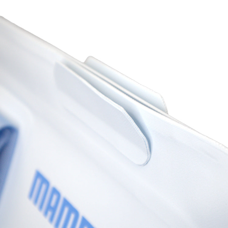 Close-up of a white product with 'MAM' branding on a light gray background