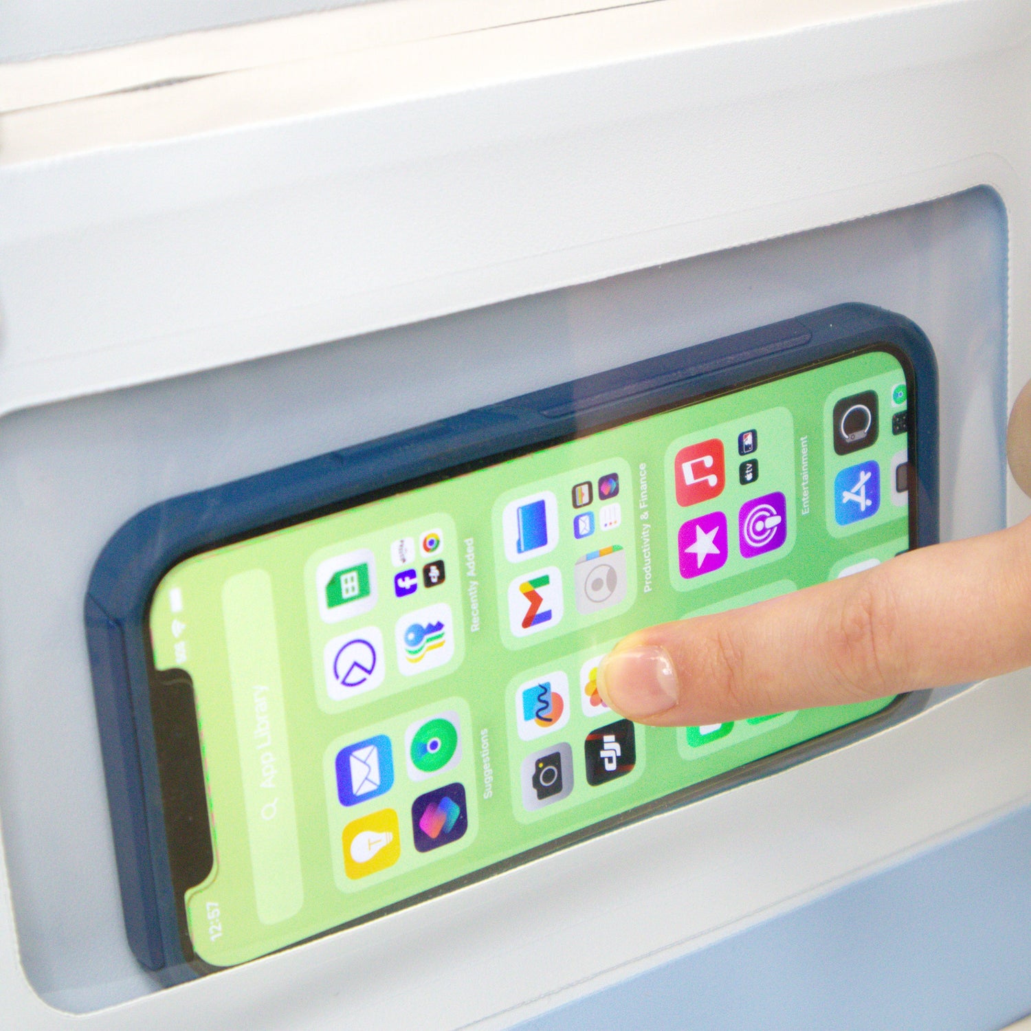 Phone with colorful app icons on a screen, held by a hand.