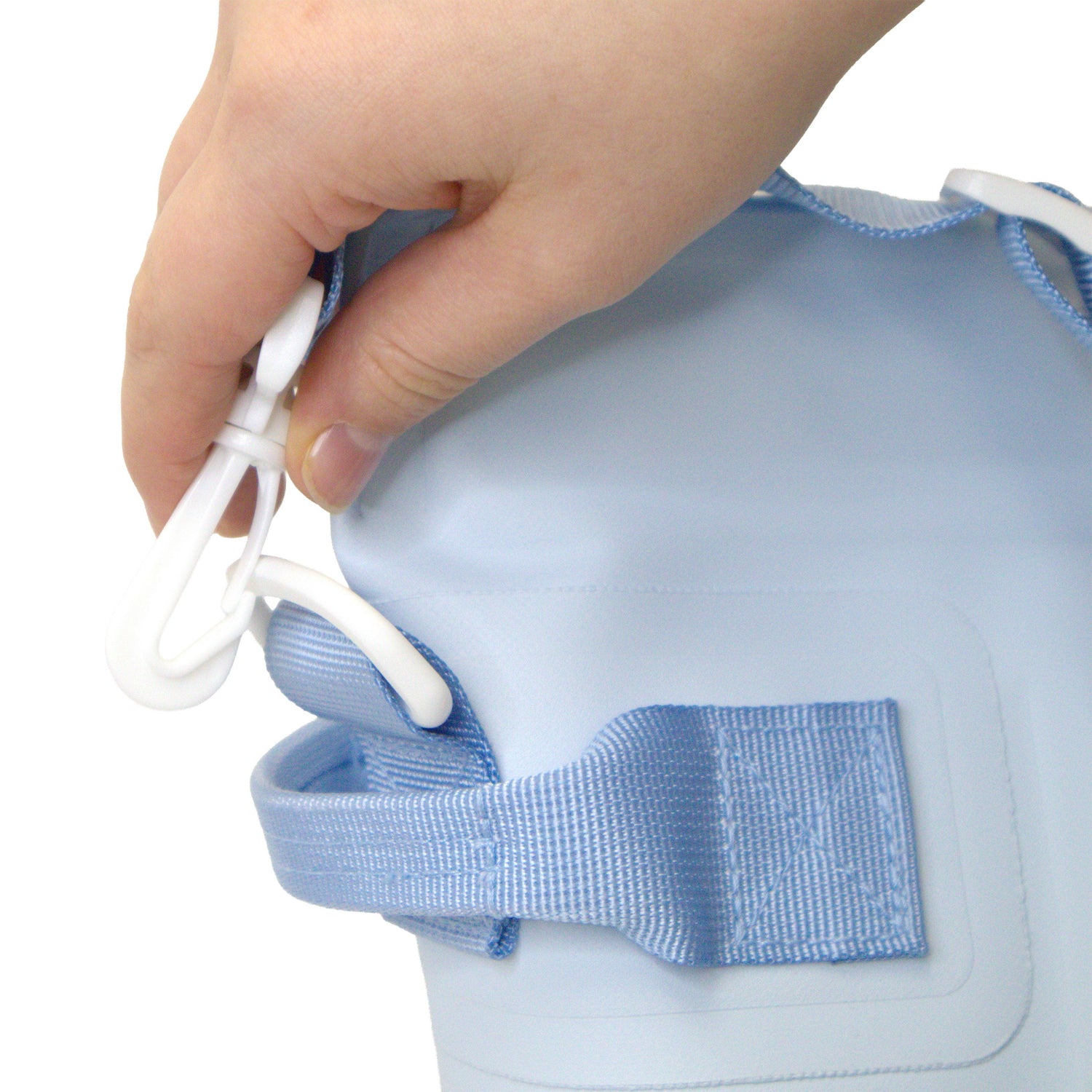 Hand adjusting a blue strap on a white background