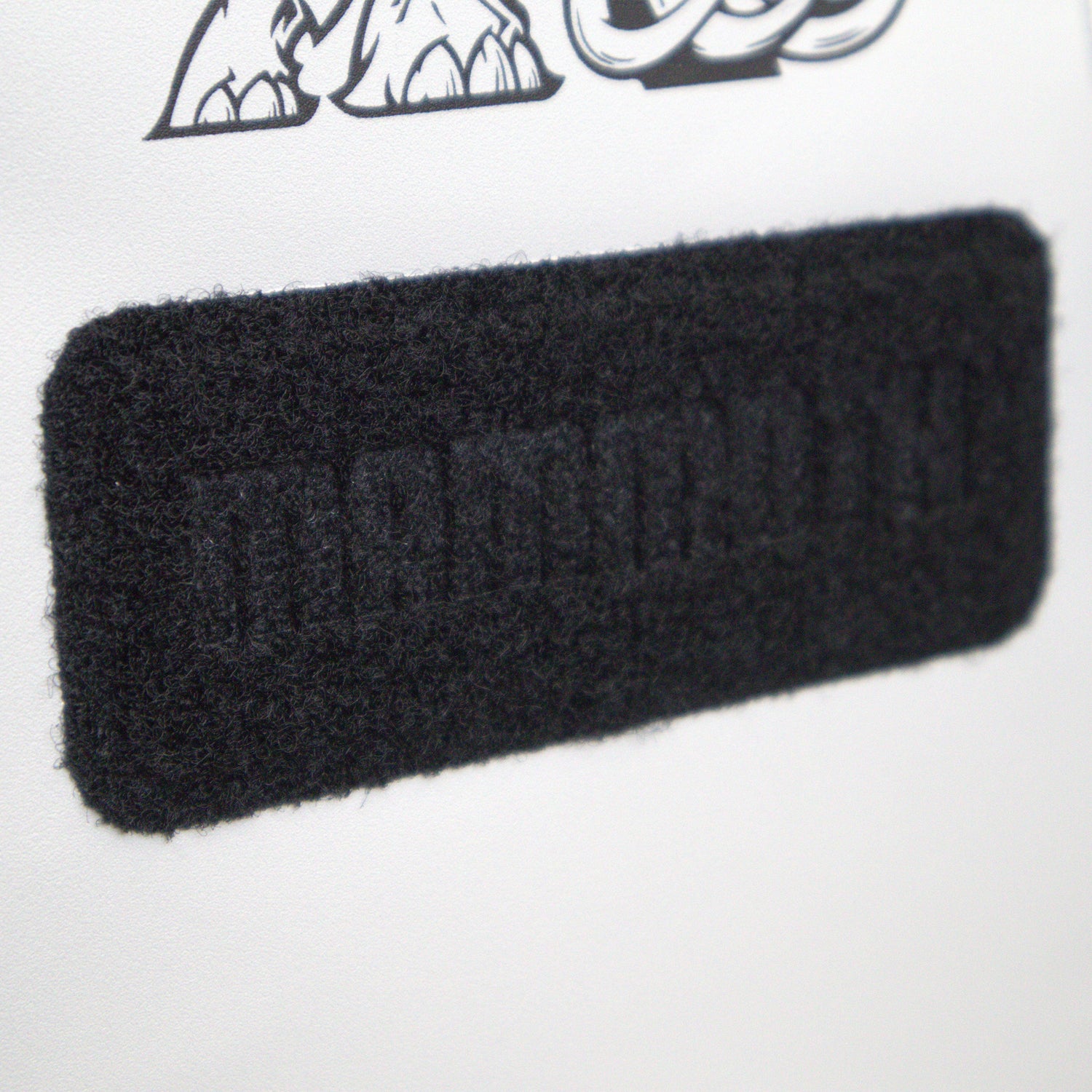 Black rectangular patch with text on a white background